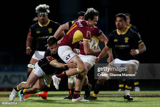 Lewis Ormond of Southland is tackled by Wes Goosen of Wellington during the round eight Mitre 10 Cup match between Southland and Wellington at Rugby...