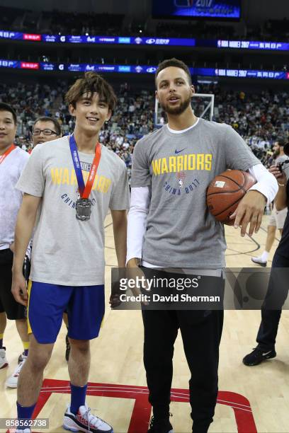 Leo Wu and Stephen Curry of the Golden State Warriors pose for a photo during fan day as part of 2017 NBA Global Games China on October 7, 2017 at...