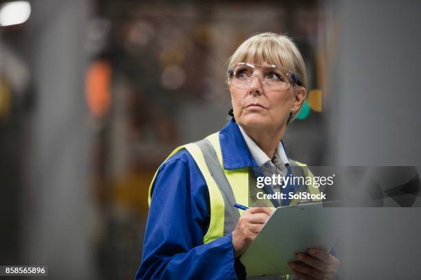 portrait of a female factory surveyor - manufacturing occupation stock pictures, royalty-free photos & images