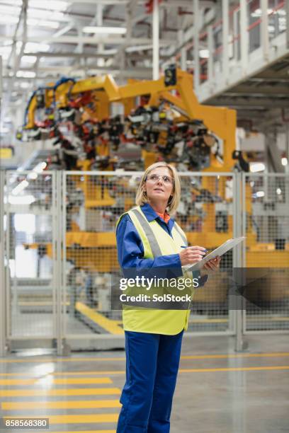 pregnant factory worker - reflective clothing stock pictures, royalty-free photos & images