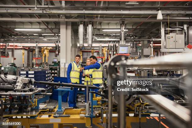 factory workers discussing on the production line - computer aided manufacturing stock pictures, royalty-free photos & images