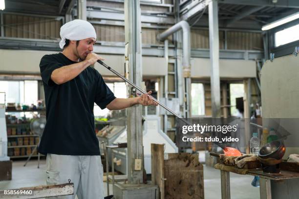 man working at a glass factory - glass blowing stock pictures, royalty-free photos & images