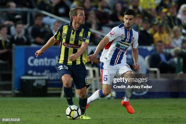 Wout Brama of the Mariners contests the ball against Steven Ugarkovic of the Jets during the round one A-League match between the Central Coast...