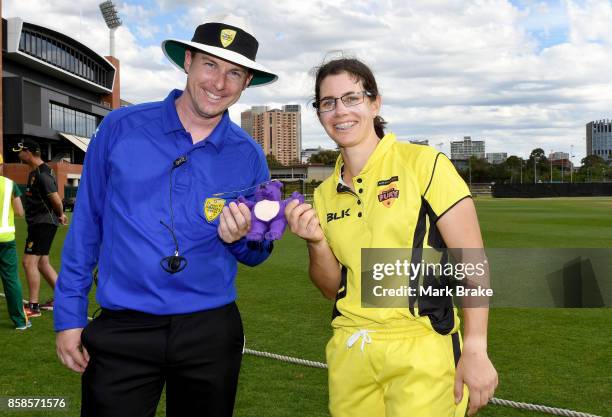 Player of the match Nicole Bolton receives the teddy bear award from umpire Luke Uthenwoldt during the WNCL match between Tasmania and Western...