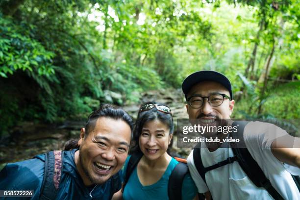 exploring a forest in okinawa japan - photographing self stock pictures, royalty-free photos & images