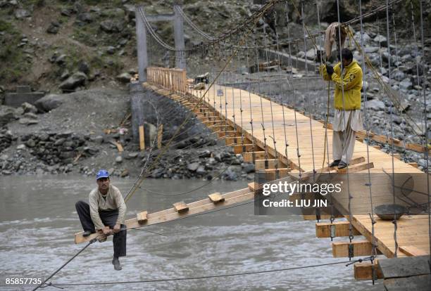 Afghanistan-unrest-military-aid-development,FOCUS by Charlotte McDonald-Gibson Afghan labourers take part in the construction of a bridge at...