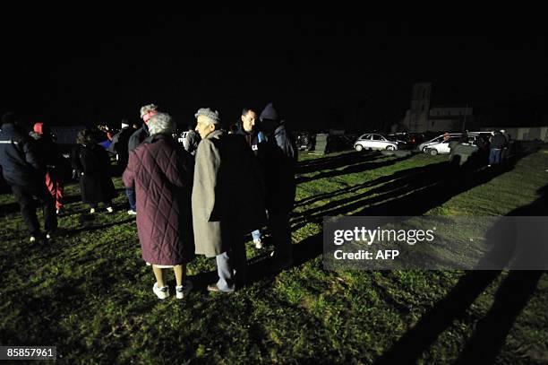 Evacuated people prepare to spend the night in tents in the village of Santa Rufina of Rojo, 12 km from L'Aquila on April 7, 2009. Strong aftershocks...