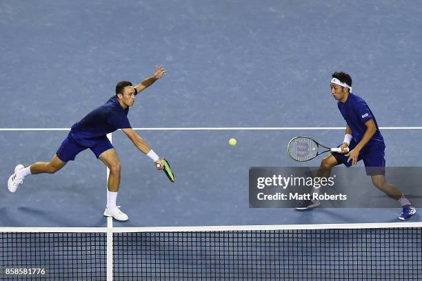 Ben McLachlan of Japan plays a backhand with doubles partner Yasutaka Uchiyama of Japan in the men's doubles semi final match against Santiago...