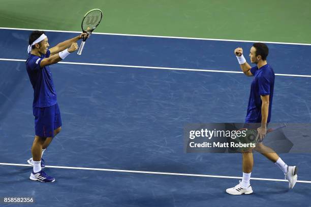 Ben McLachlan of Japan and Yasutaka Uchiyama of Japan celebrate winning their men's doubles semi final match against Santiago Gonzalez of Mexico and...