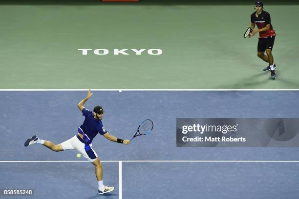 Santiago Gonzalez of Mexico plays a backhand with doubles partner Julio Peralta of Chile in the men's doubles semi final match against Ben McLachlan...