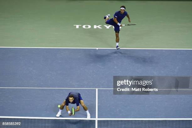 Yasutaka Uchiyama of Japan serves with doubles partner Ben McLachlan of Japan in their men's doubles semi final match against Santiago Gonzalez of...