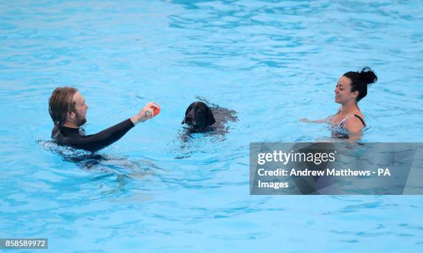 Ellie and Richard from Telscombe swim with their pointer dog Cooper at Saltdean Lido in the Oval Park, Saltdean, as the lido has invited dogs to...