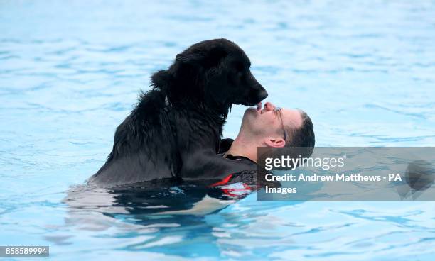 Chris Heath from Crawley swims with his German shepherd husky cross dog Pepsi at Saltdean Lido in the Oval Park, Saltdean, as the lido has invited...