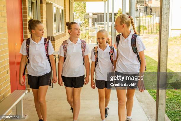 girl junior high school students arriving at school - first day of school australia stock pictures, royalty-free photos & images