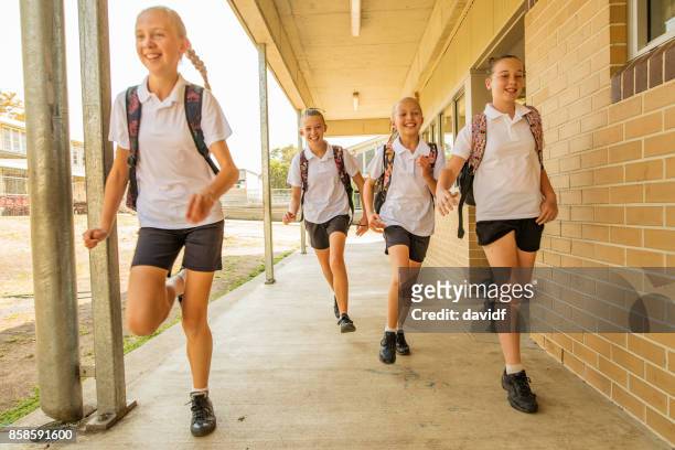 excited girl junior high school students running at school - last day of school stock pictures, royalty-free photos & images