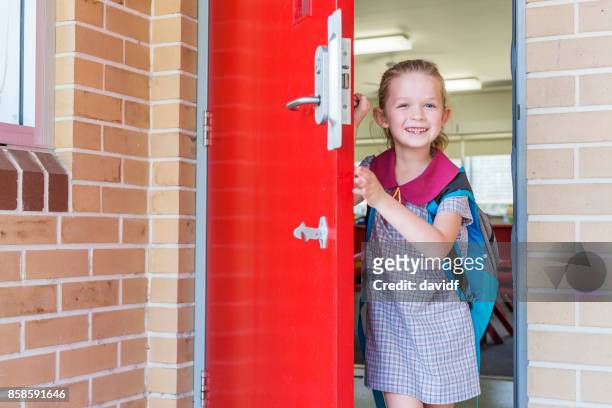 kindergarten primary school girl student arriving for class - first day of school australia stock pictures, royalty-free photos & images