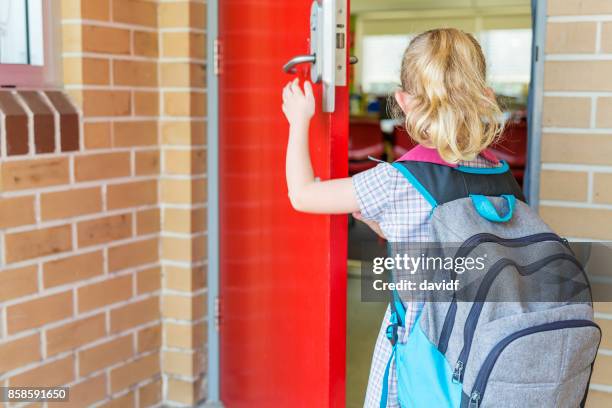 kindergarten primary school girl student arriving for class - first day of school australia stock pictures, royalty-free photos & images