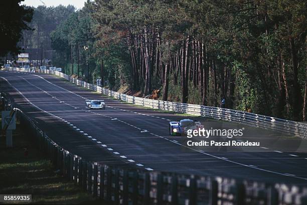 Porsche 962C, of the Joest Porsche Racing team, leads a Toyota 90C-V down the Mulsanne straight during the 24 Hours of Le Mans, 16th-17th June 1990.