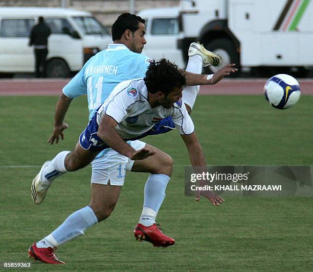 Jordanian al-Faisaly's Abdelhadi al-Maharmeh vies for the ball with Syrian al-Majd's Khaled al-Baba during their AFC Cup group E football match in...