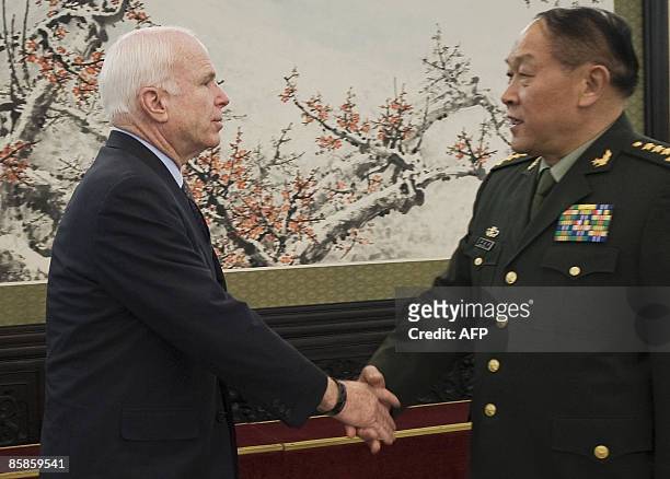 Senator John McCain is greeted by Chinese Defense Minister Liang Guanglie during his visit to the Bayi building in Beijing, onApril 8, 2009. AFP...