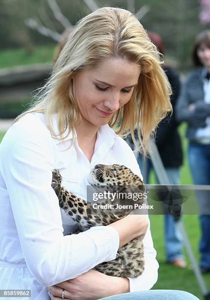 Personality Judith Rakers is seen with one of the two six-week-old North Chinese Leopards during a name giving ceremony at Hagenbeck Zoo on April 8,...