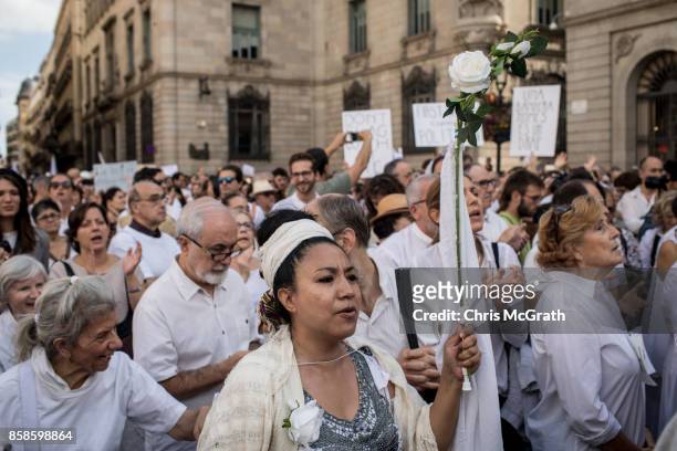 Thousands of people, dressed in white gather and chant the slogan "lets talk" outside the Barcelona City Hall on October 7, 2017 in Barcelona, Spain....