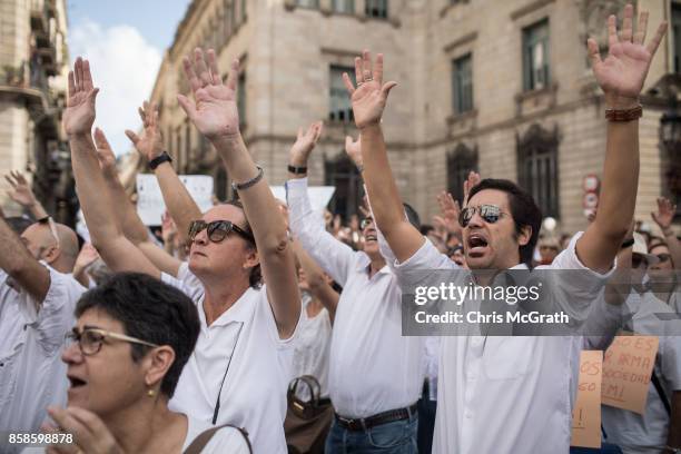 Thousands of people, dressed in white gather and chant the slogan "lets talk" outside the Barcelona City Hall on October 7, 2017 in Barcelona, Spain....