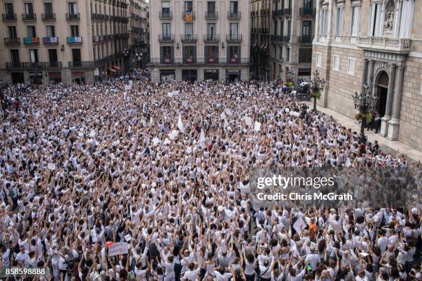 Thousands of people, dressed in white gather and chant the slogan "lets talk" outside the Barcelona City Hall on October 7, 2017 in Barcelona, Spain....