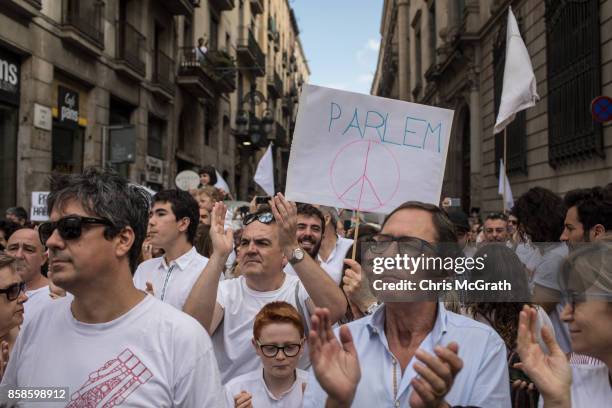 Thousands of people, dressed in white gather and chant the slogan "lets talk" outside the Barcelona City Hall on October 7, 2017 in Barcelona, Spain....