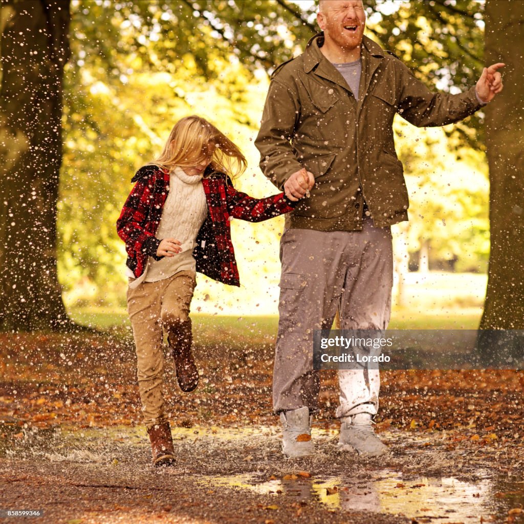 Father and Beautiful young blond daughter in Autumnal Park