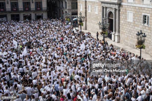 Thousands of people, dressed in white gather and chant the slogan "lets talk" outside the Barcelona City Hall on October 7, 2017 in Barcelona, Spain....