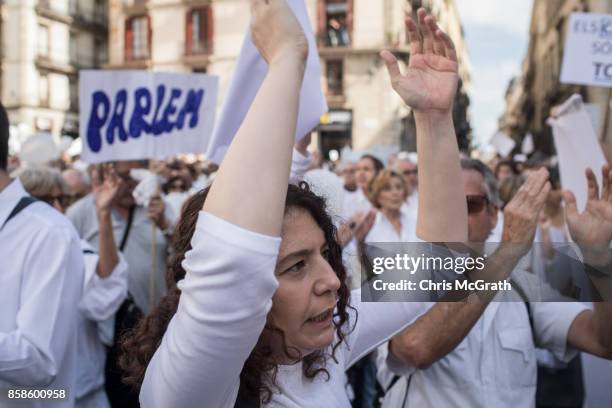 Thousands of people, dressed in white gather and chant the slogan "lets talk" outside the Barcelona City Hall on October 7, 2017 in Barcelona, Spain....