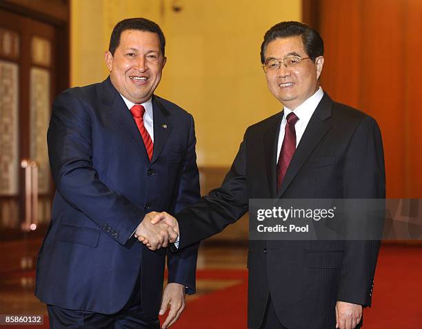 Venezuelan President Hugo Chavez , shakes hand with Chinese President Hu Jintao during their meeting at the Great Hall of the People on April 8, 2009...