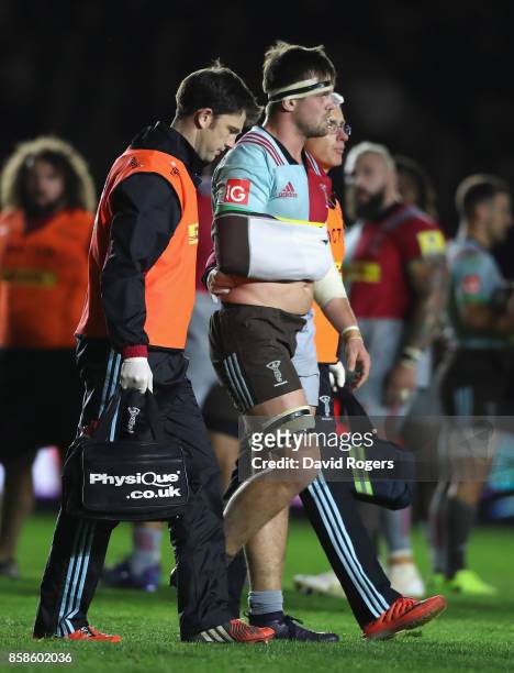 Jack Clifford of Harlequins is helped off the pitch after dislocating his arm during the Aviva Premiership match between Harlequins and Sale Sharks...