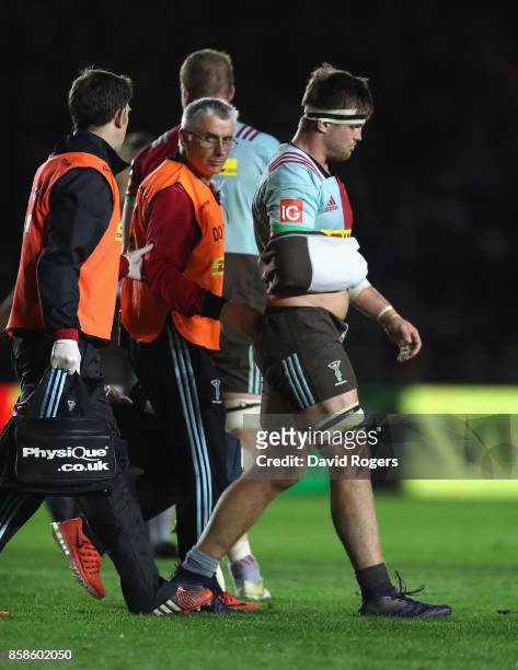 Jack Clifford of Harlequins is helped off the pitch after dislocating his arm during the Aviva Premiership match between Harlequins and Sale Sharks...