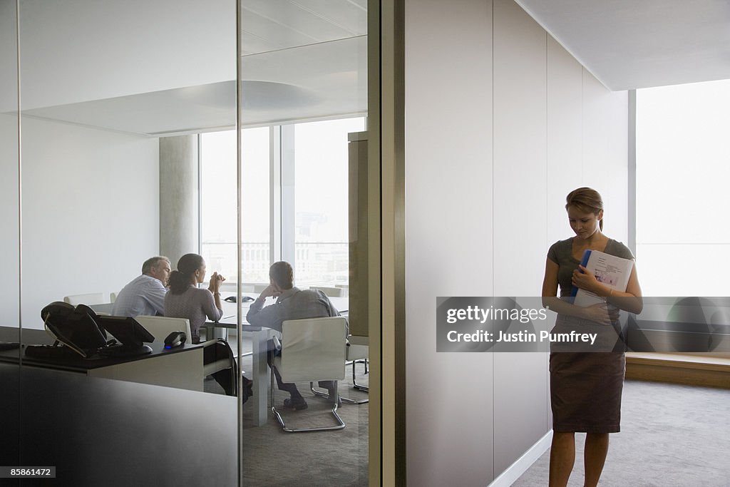 Business meeting and businesswoman in corridor