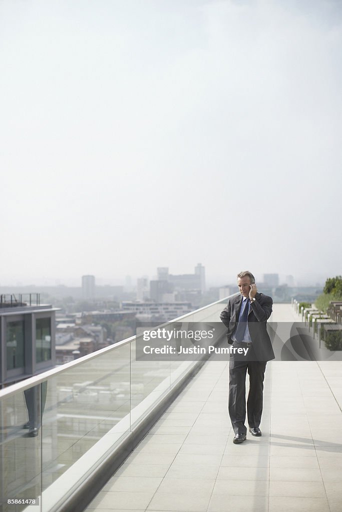 Businessman on rooftop using mobile