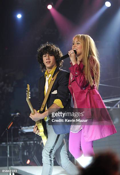 Nick Jonas of the Jonas Brothers and Miley Cyrus perform during her "Best of Both Worlds" tour at Nassau Coliseum on December 27, 2009 in Uniondale,...