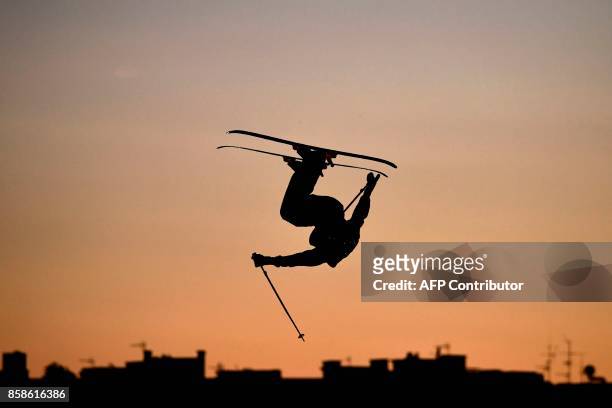 Freestyle skier perofrms in the Sosh Big Air, a competition of freestyle skiers and snowboarders, in Annecy, at sunset on October 6, 2017 as part of...