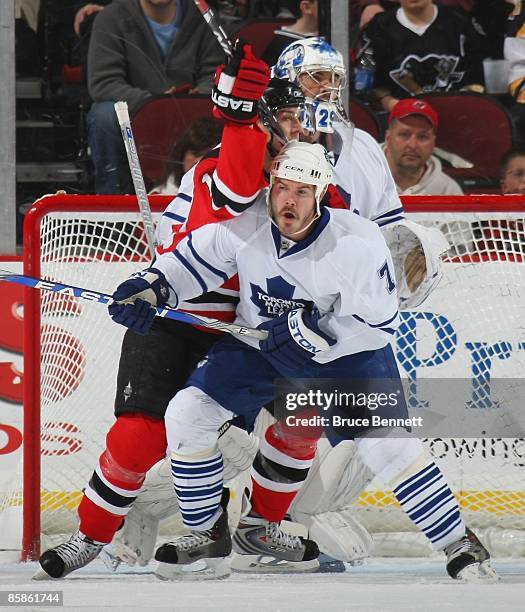 Ian White of the Toronto Maple Leafs defends against Travis Zajac of the New Jersey Devils on April 7, 2009 at the Prudential Center in Newark, New...