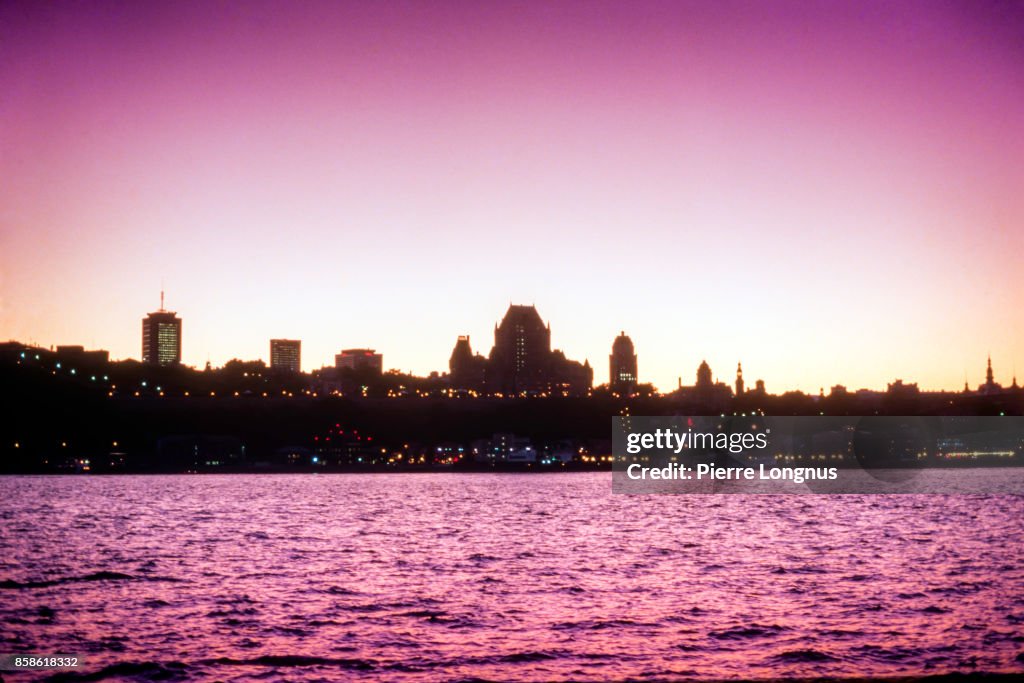 Silhouette view at dusk of the Historic district of Quebec City from the other side of the the St. Lawrence River, Quebec, Canada