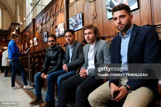 Syrian photographers working for AFP Karam al-Massri, Baraa Al-Halabi, Ameer Alhalbi and Zakaria Abdelkafi pose during a photography exhibition in...