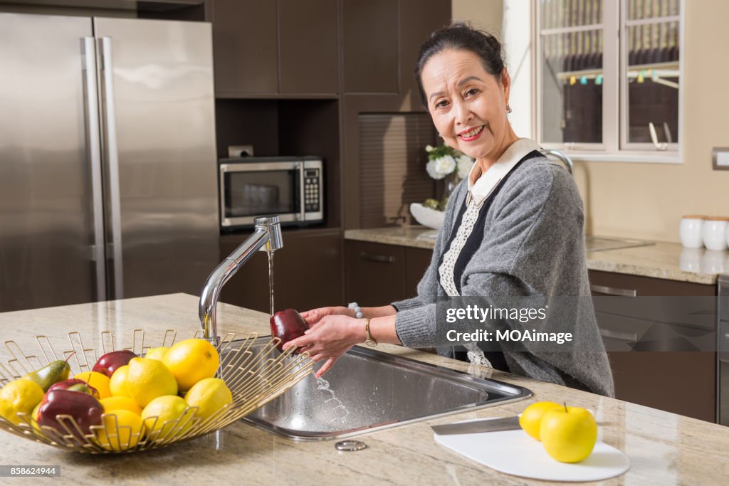 Fashionable mature woman in the modern kitchen