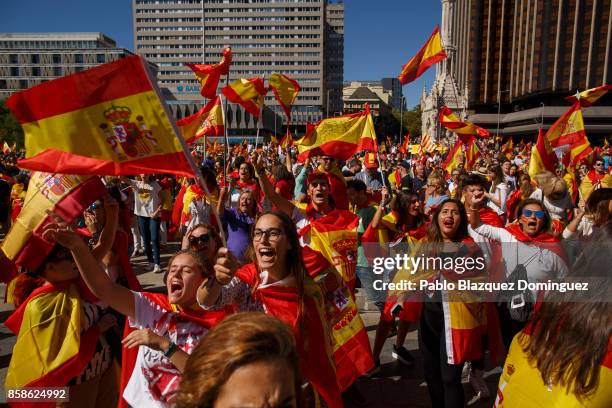 Demonstrators shout slogans and hold Spanish flags as they protest against the independence of Catalonia under the slogan 'For the defense and unity...