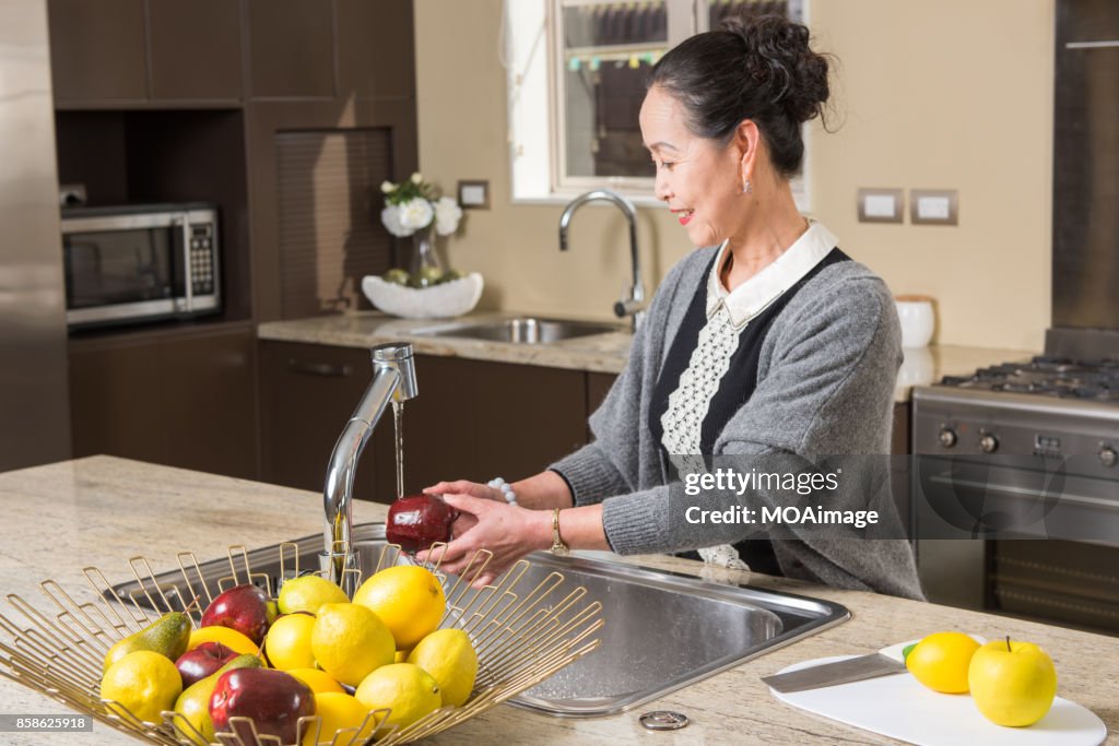 Fashionable mature woman in the modern kitchen