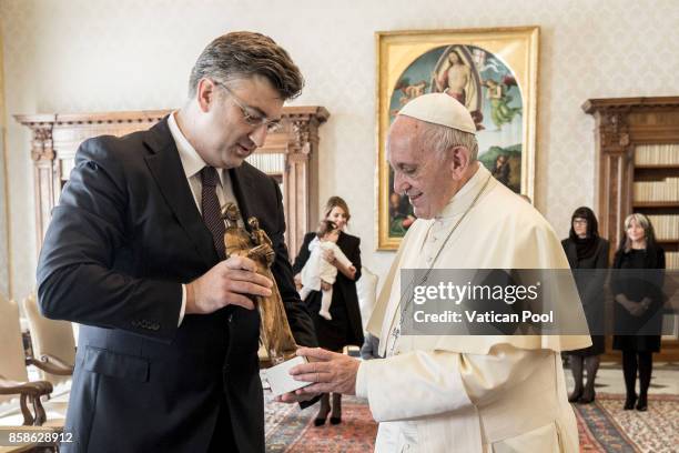 Pope Francis exchanges gifts with Croatia's Prime Minister Andrej Plenkovic and his family during an audience at the Apostolic Palace on October 7,...