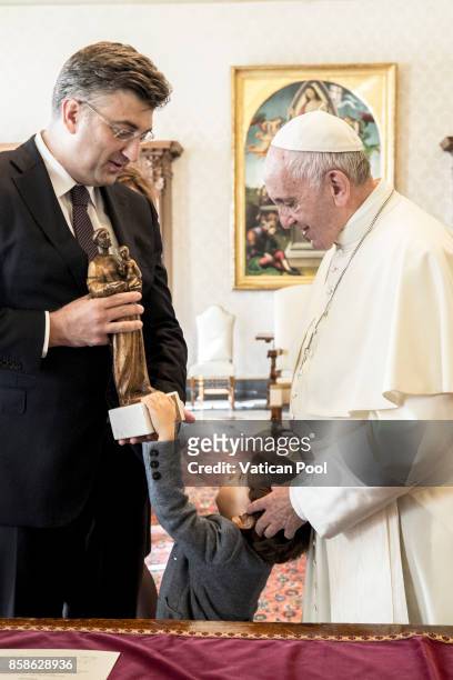 Pope Francis exchanges gifts with Croatia's Prime Minister Andrej Plenkovic and his family during an audience at the Apostolic Palace on October 7,...