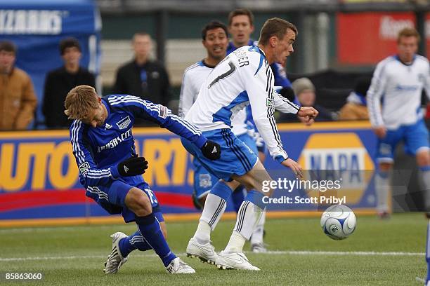 Aaron Hohlbein of the Kansas City Wizards goes down after a collision with Cam Weaver of the San Jose Earthquakes at Community America Ballpark in...