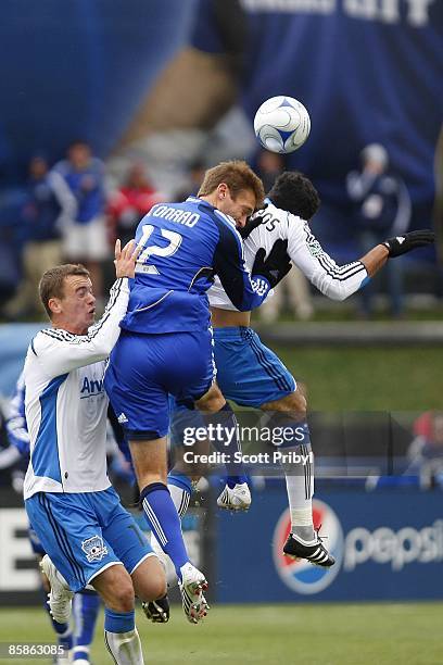 Jimmy Conrad of the Kansas City Wizards wins a head ball against Pablo Campos and Cam Weaver of the San Jose Earthquakes at Community America...