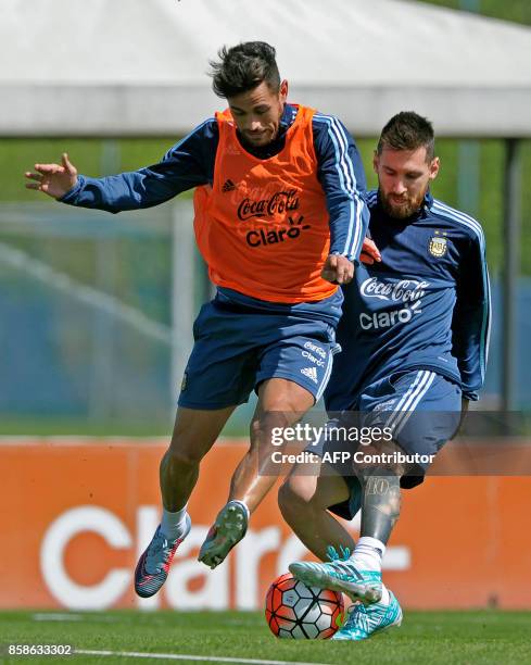 Argentina's forwards Lionel Messi and Lautaro Acosta take part in a training session in Ezeiza, Buenos Aires on October 7, 2017 ahead of a 2018 FIFA...